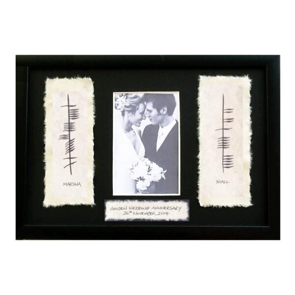 Ogham Wedding Anniversary Photo Frame gift made in Ireland. Photo frame with couples' names written in Ogham on handmade paper in a slim black frame