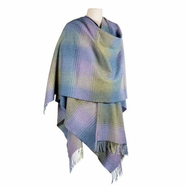 100% Lambswool Cape, beautiful mix of blue, green and lilac colours in a large check pattern. Designed and made in Ireland by John Hanly