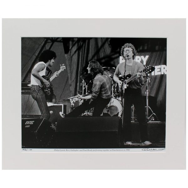 Rory, Phil & Paul - photographic print of Rory Gallagher, Phil Lynott & Paul Brady playing in concert together at Punchestown in 1982, taken & signed by Hot Press Photographer Colm Henry